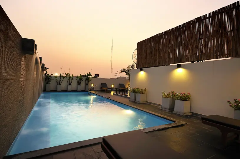 Rooftop swimming pool at Sleep Withinn Hotel Khaosan at sunset